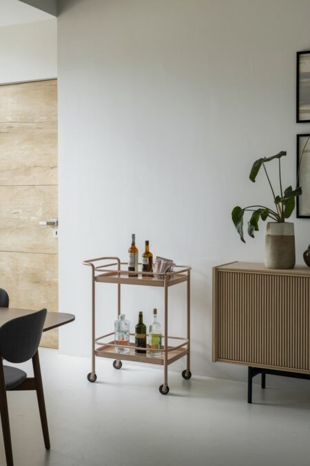 modern dining room with a bar cart placed near the sideboard
