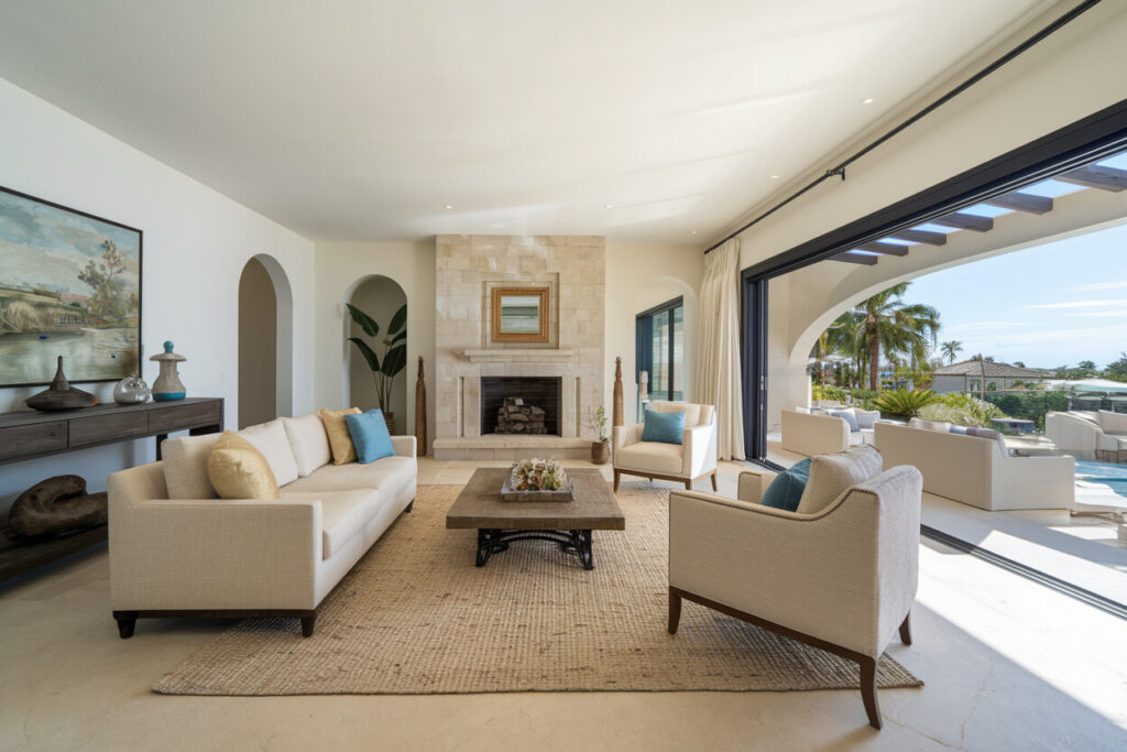 Mediterranean style living room with a fireplace, light color couch and armchairs, jute area rug