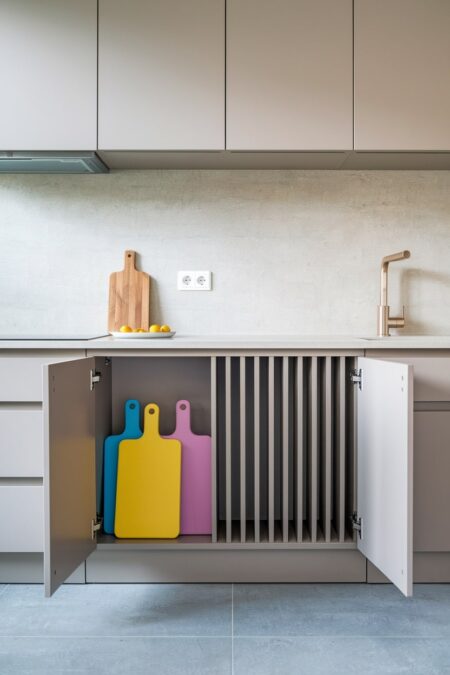 small kitchen with vertical cabinet dividers for cutting board organization