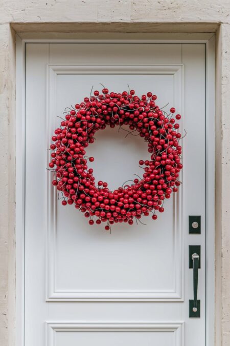 artificial cherry summer wreath on the white front door