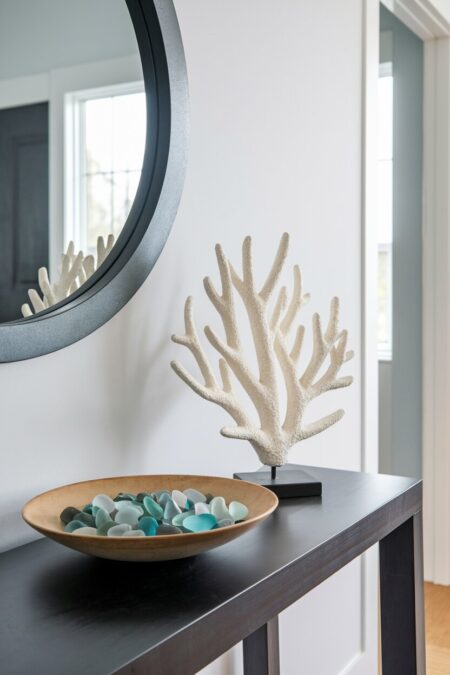 bowl of sea glass and coral sculpture on the console table as summer entryway decor