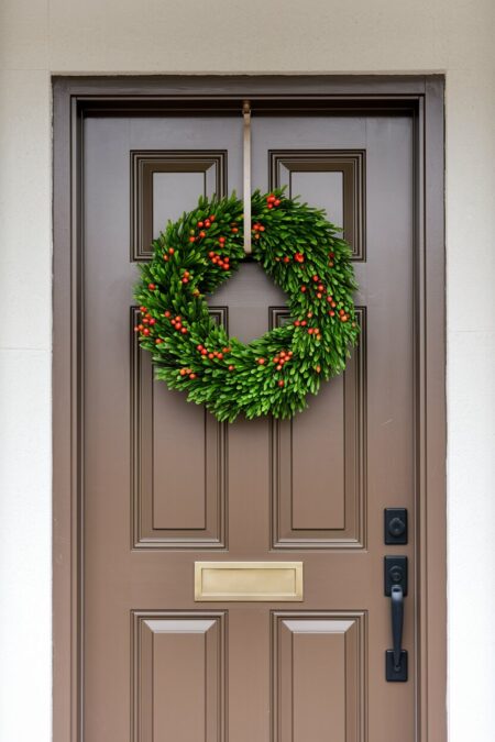 boxwood wreath with small artificial red berries as summer door decor