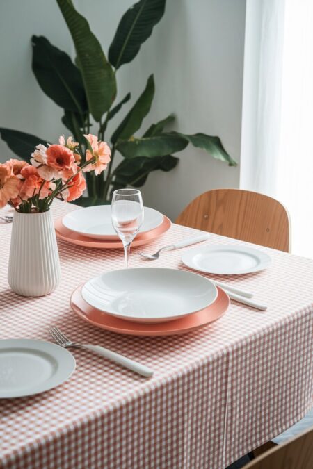 checkered tablecloth in soft peach with solid color plates as summer table decor