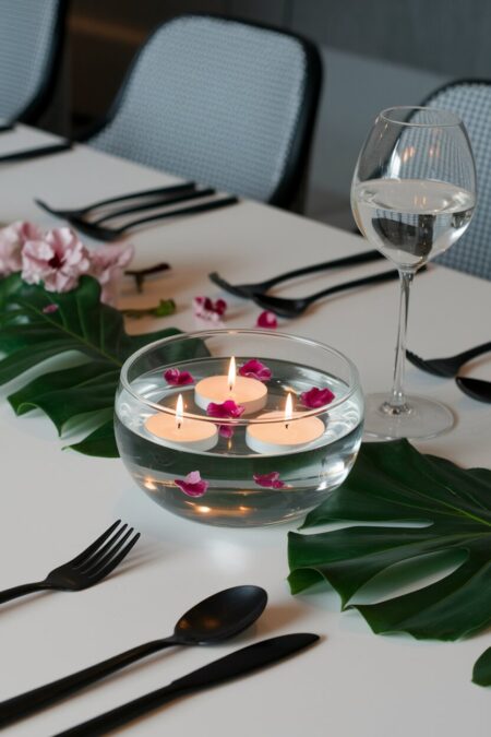 glass bowl with floating candles and petals as summer table decor