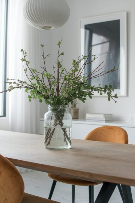 large glass jar with fresh branches as summer dining room decor