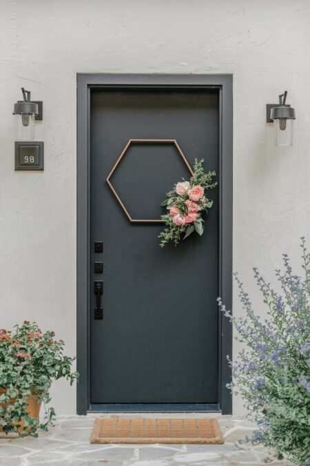 modern hexagonal metal frame with flowers as summer door decor