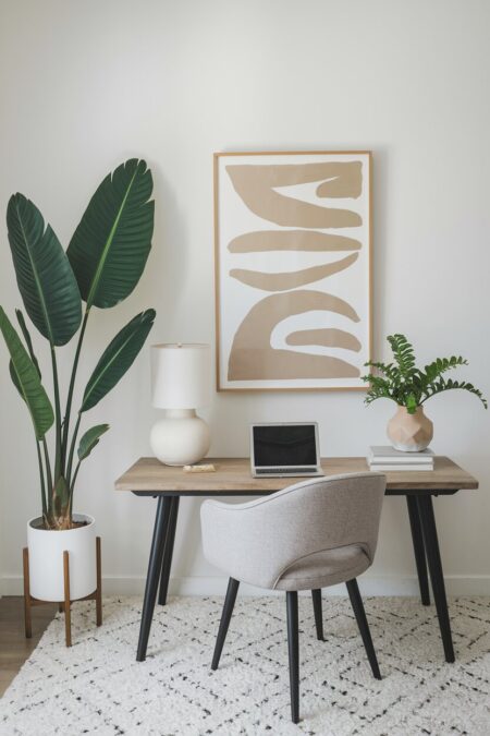 neutral home office with a Bird of Paradise indoor plant as summer decor