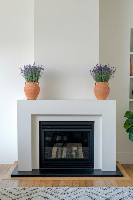 symmetrical terracotta pots filled with lavender as summer mantel decor