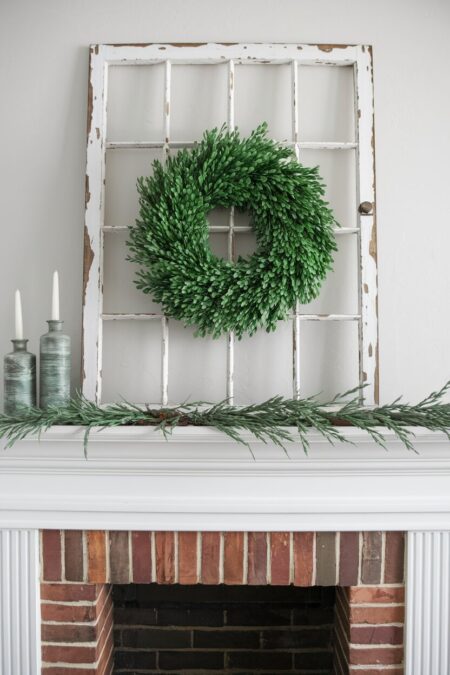 white window frame and boxwood wreath in the center as farmhouse summer mantel decor