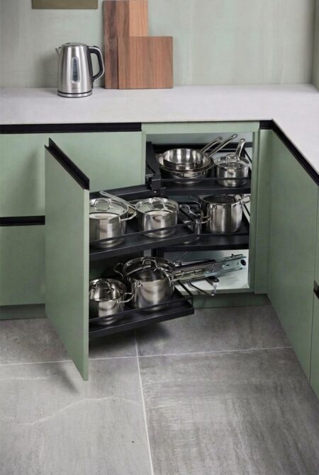 blind corner pull out organizer with cookware in the green kitchen