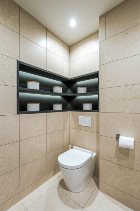 built-in over-the-toilet corner shelving
