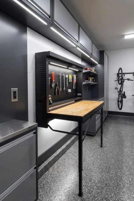 folding wall-mounted workbench with storage in the garage