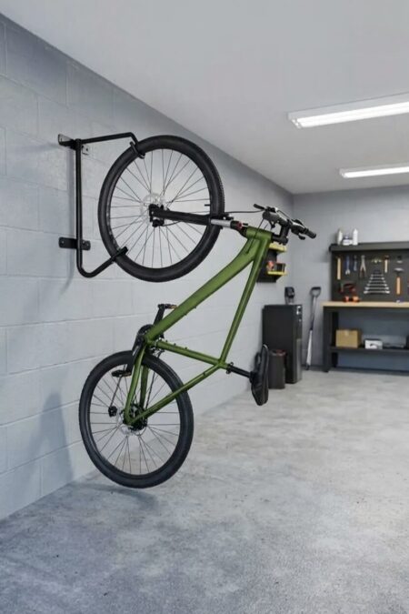 vertical bike rack with a green bike in the light garage