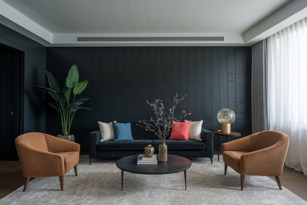 dark living room with velvet furniture, a light gray area rug, and color accents in throw pillows