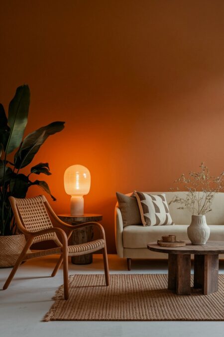 earthy living room with warm amber lighting, a wood coffee table, and a neutral sofa