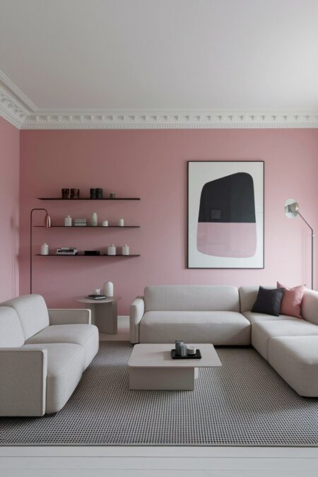 modern pink living room with low gray sofas, black and white area rug, abstract artwork, black floating shelves
