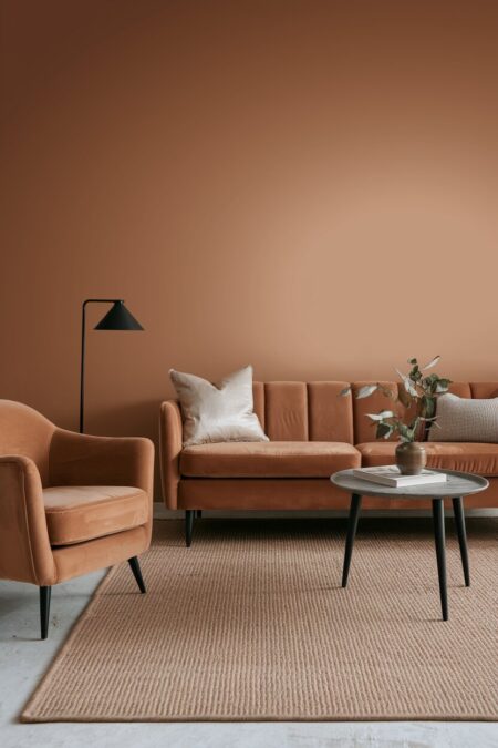 monochromatic neutral living room in a dusty camel tone with a velvet sofa
