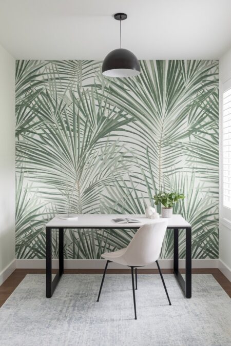 modern home office with a green botanical wallpaper and simple black and white furniture