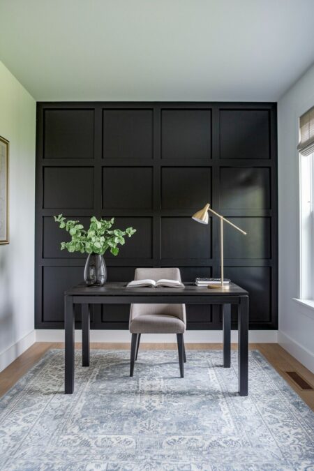 contemporary home office with a black accent wall with board and batten, and a black desk