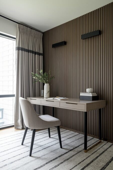 contemporary home office with slat wood paneling and black accents