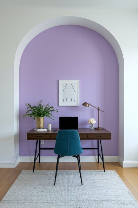 home office with a lavender accent wall, dark walnut desk, and a navy blue chair