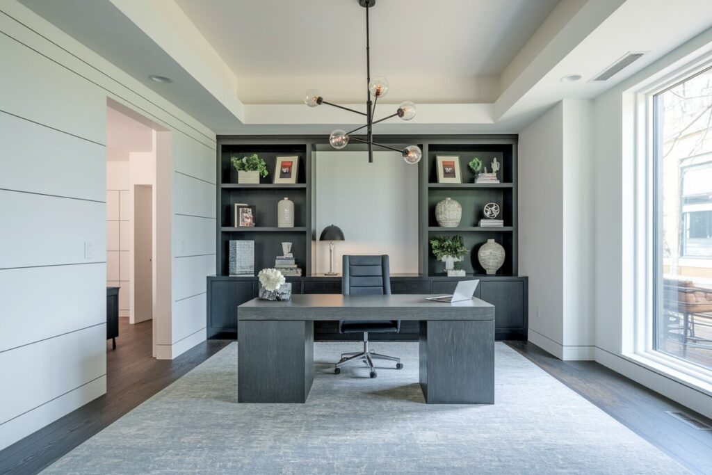 11 Modern Home Office Ideas Built for Peak Daily Output modern home office with white walls, dark furniture, and a large gray area rug