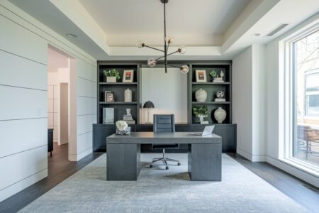 11 Modern Home Office Ideas Built for Peak Daily Output modern home office with white walls, dark furniture, and a large gray area rug