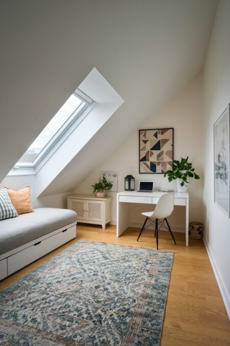 attic office guest room with sloped ceiling, a simple desk, and a daybed