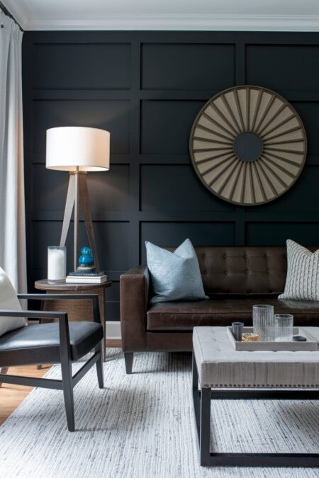 masculine living room with a dark charcoal wall with board and batten and a dark brown leather couch