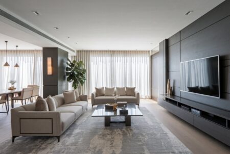 open plan contemporary luxury living room with two sofas, wall panels, a TV and, a floating console