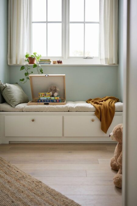 built-in window seat with drawers and toys on top