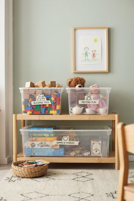labeled clear plastic storage bins with toys inside