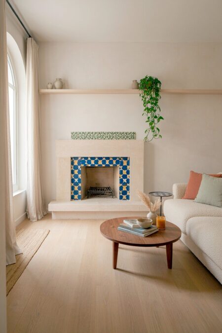 Mediterranean living room with blue and yellow handmade tile around a fireplace and on top of the side table