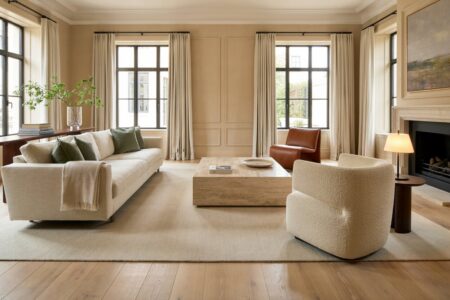transitional living room has contemporary track-arm sofa, a fireplace, leather and boucle accent chairs
